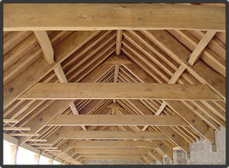 Heavily stained beams sandblasted to expose the grain